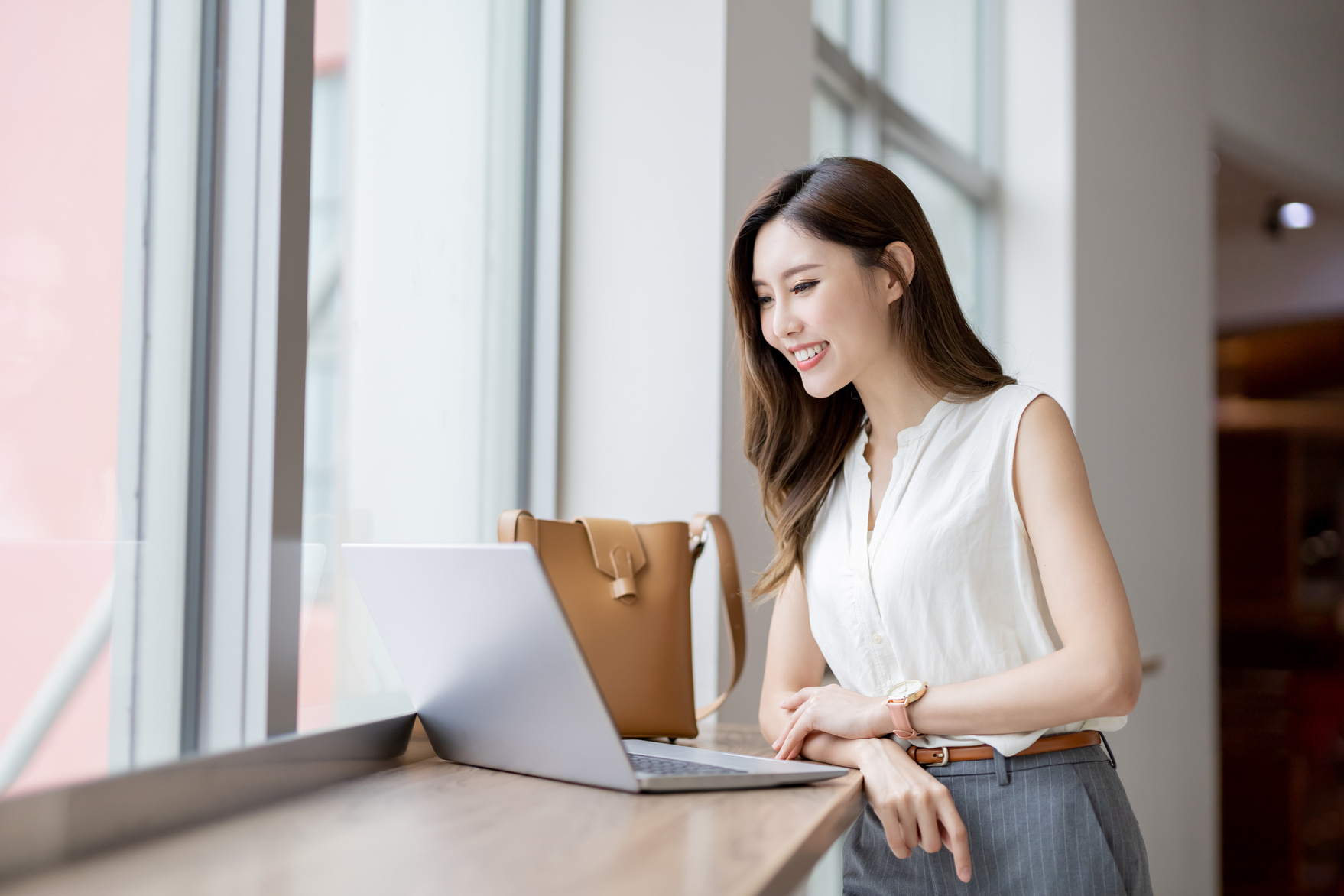  Woman Using Laptop at a Cafe